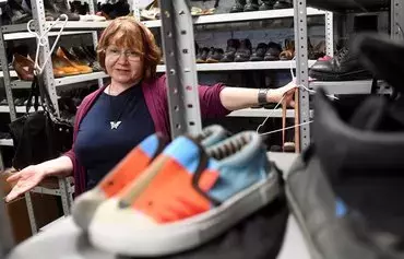 Volunteer Galina Artyomenko, 58, reacts during an interview with AFP at a humanitarian aid warehouse in St. Petersburg on July 28. [Olga Maltseva/AFP]