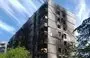 
Shown is Gennady's apartment building, which was burned during the attack on Mariupol. The building went up in flames in summer 2022, but his apartment escaped damage. [Gennady's personal archive]        