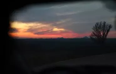 This photograph taken on November 13 at sunset shows a view taken from a car outside Avdiivka, Donetsk province, amid the Russian invasion in Ukraine. [Anatolii Stepanov/AFP]