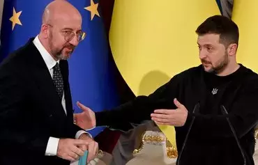 Ukrainian President Volodymyr Zelenskyy (right) gestures towards European Council President Charles Michel (left) after a joint news conference following their talks in Kyiv on November 23, amid the Russian invasion of Ukraine. [Sergei Supinsky/AFP]