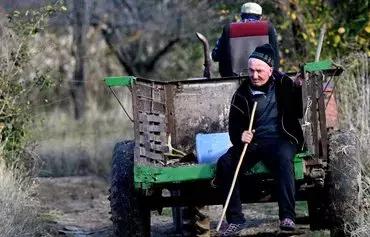 Villagers ride a tractor in Ditsi at Georgia's de facto border with its breakaway region of South Ossetia on November 13. [Vano Shlamov/AFP]