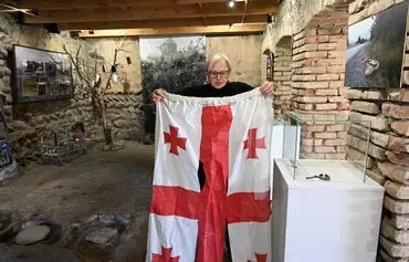 Local resident Lia Chlachidze talks to an AFP reporter at her makeshift Museum of August 2008, commemorating the Russian-Georgian War, organized in her wine cellar in the village of Ergneti at Georgia's de facto border with its breakaway region of South Ossetia on November 13. [Vano Shlamov/AFP]