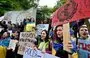 
Ukrainian students protest ecocide during a rally outside the United Nations (UN) office in Kyiv on June 8, one day after the destruction of a Russian-held dam in Ukraine sparked fears of a humanitarian disaster. [Sergei Supinsky/AFP]        