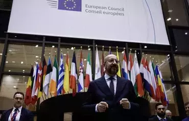 EC President Charles Michel arrives to deliver remarks to journalists at the end of the first day of an EU summit in Brussels on December 15. [Kenzo Tribouillard/AFP]