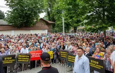 Supporters of the Șor party gather to protest outside the Constitutional Court of Moldova as it rules on the opposition party's constitutionality, in Chisinau on June 19. The court banned the party. [Elena Covalenco/AFP]