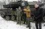 
Lithuanian Defense Minister Arvydas Anusauskas (left) attends the testing of a Leopard 2 tank at the Gaiziunai military training area near the Rukla military base in Lithuania,on December 15. The tank was brought from combat in Ukraine and was repaired in Lithuania. [Petras Malukas/AFP]        