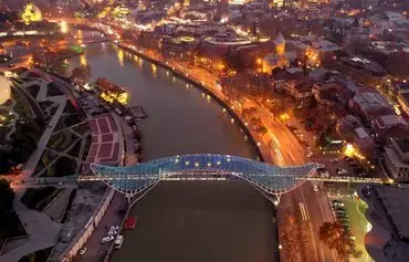 This aerial view taken in Tbilisi on December 16 shows the Bridge of Peace illuminated in EU flag colors to mark Georgia's EU candidate status. [Vano Shlamov/AFP]