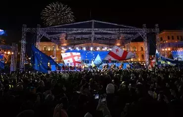 Georgians rally to celebrate their country's EU candidate status in Tbilisi on December 15. [Vano Shlamov/AFP]