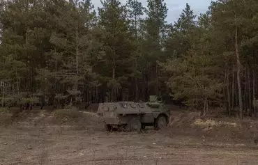 A French-made armored personnel carrier VAB operated by a Ukrainian soldier runs in the Donetsk region on January 21, amid the Russian invasion of Ukraine. [Roman Pilipey/AFP]