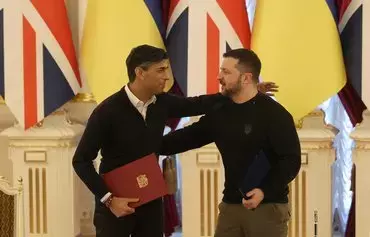 President of Ukraine Volodymyr Zelenskyy (right) and Prime Minister of the United Kingdom Rishi Sunak (left) hug after an agreement signing ceremony following their meeting in Kyiv, on January 12, amid the Russian invasion of Ukraine. [Anatolii Stepanov/AFP]