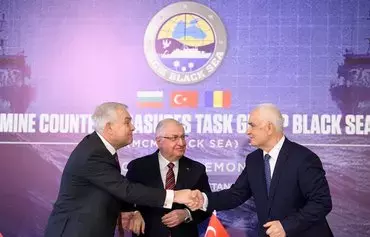 Turkish Defense Minister Yasar Guler (C), Romanian Defense Minister Angel Tilvar (L) and Bulgarian Deputy Defense Minister Atanas Zapryanov (R) shake hands after signing an agreement on demining the Black Sea to ensure safe waters after Russia's war in Ukraine, in Istanbul, on January 11. [Yasin Akgul/AFP]