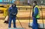 
Uzbek migrant workers are shown clearing snow in Moscow last February 23. [File]        