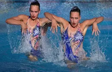 Ukraine's Maryna Aleksiiva and Vladyslava Aleksiiva compete in the preliminaries for the women's duet technical artistic swimming event during the Budapest 2022 World Aquatics Championships on June 17, 2022. [Attila Kisbenedek/AFP]