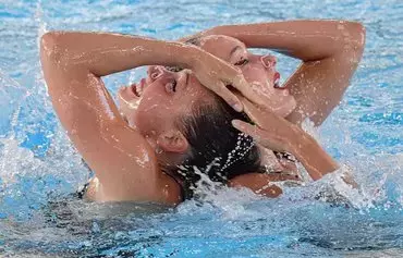 Ukraine's Maryna Aleksiiva and Vladyslava Aleksiiva compete during the Women's Artistic Swimming duet free final event on August 13, 2022, at the LEN European Aquatics Championships in Rome. [Filippo Monteforte/AFP]