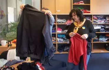 Volunteers sort clothes at the Matusya association, which supports Ukrainian refugees in Vienna, Austria, on February 8. [Alex Halada/AFP]