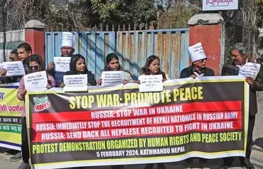 Human rights activists hold placards during a demonstration outside the Russian embassy in Kathmandu on February 5, to protest the recruitment of Nepali nationals into the Russian army. [Prakash Mathema/AFP]