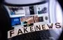 
This illustration photograph shows letters reading 'fake news' seen through a magnifying glass, against a laptop screen displaying other illustration images of various alleged fake news, disinformation campaigns or conspiracy theories, in Mulhouse, France, on December 1. [Sebastien Bozon/AFP]        