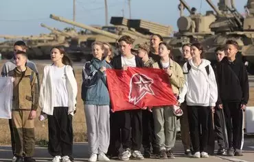 Schoolchildren hold a flag of Young Army Cadets National Movement during training in the the military-patriotic program 'School of Future Commanders' in Sevastopol, Russian-occupied Ukraine, on October 28. The training conducted under the guidance of military personnel includes disciplines such as multi-sport racing, tactical medicine and weapon handling. [AFP]