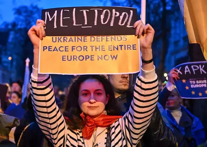 Demonstrators march in downtown Budapest to mark the second year of Russia's invasion of Ukraine on February 24, near the Russian embassy. [Attila Kisbenedek/AFP]