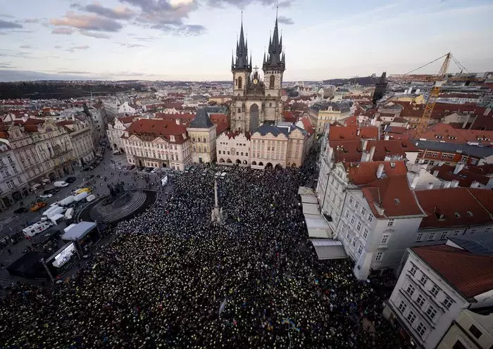 Demonstrators February 24 in Prague hold blue and yellow papers over their heads to form Ukrainian colors while commemorating the second anniversary of the Russian invasion of Ukraine. [Michal Cizek/AFP]