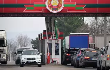 Cars wait in line at the Bender crossing point between the self-proclaimed republic of Transnistria and Moldova on March 1. [Daniel Mihailescu/AFP]