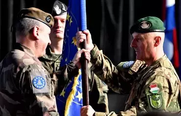 French Lt.-Gen. and EUFOR Operational Commander Hubert Cottereau (left) hands over the mission flag to incoming mission commander Hungarian Maj.-Gen. Laszlo Sticz during the handover ceremony for EUFOR's Althea mission in Sarajevo, Bosnia-Herzegovina, January 31. [Elvis Barukcic/AFP]