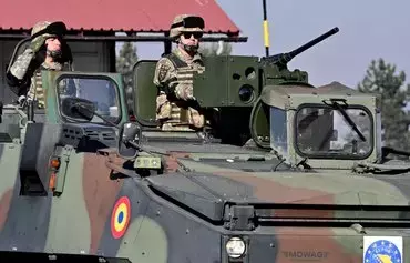 Romanian soldiers drive a Momag assault vehicle during the handover ceremony for EUFOR's Althea mission in Sarajevo, Bosnia-Herzegovina, January 31. [Elvis Barukcic/AFP]