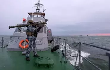 A Ukrainian serviceman holds a Stinger anti-aircraft weapon as he scans for possible air targets, onboard a Ukrainian Maritime Guard boat in the northwestern part of the Black Sea on December 18, amid the Russian invasion of Ukraine. [Anatolii Stepanov/AFP]