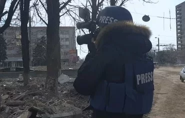 A screenshot from the documentary film '20 Days in Mariupol' shows Ukrainian photojournalist Evgeniy Maloletka capturing the destruction in the southern port city as Russian troops invade during February and March 2022.