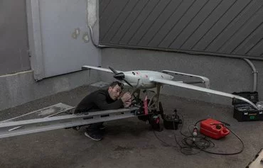 An employee works on a Raybird long-range surveillance drone at the Skyeton drone-manufacturing company, in Kyiv province, Ukraine, February 27 amid the Russian invasion of Ukraine. [Roman Pilipey/AFP]