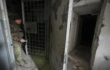 A Ukrainian policeman January 31, 2023, walks in a basement of Kherson provincial police headquarters, allegedly used as a site for torturing pro-Ukrainian citizens during the Russian occupation. [Genya Savilov/AFP]