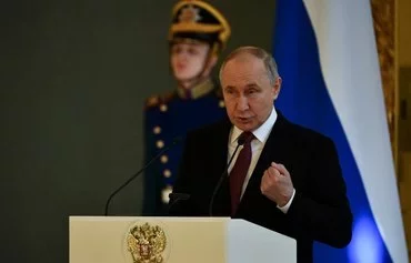 Russian President and presidential candidate Vladimir Putin meets with his election agents at the Kremlin in Moscow on March 20. [Olga Maltseva/AFP]