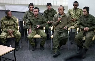 Foreign soldiers captured by Ukraine as combatants within the Russian armed forces take part in a news conference organized by Ukrainian officials in Kyiv, on March 15, amid the Russian invasion in Ukraine. [Anatolii Stepanov/AFP]