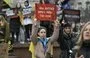 
Women hold signs reading 'Only through fighting can one survive' and 'Captivity kills, and so do silence and indifference' as relatives and friends of Ukrainian prisoners of war rally in front of the Kyiv Opera on March 17, calling for their exchange with Russian prisoners, amid the Russian invasion of Ukraine. [Genya Savilov/AFP]        