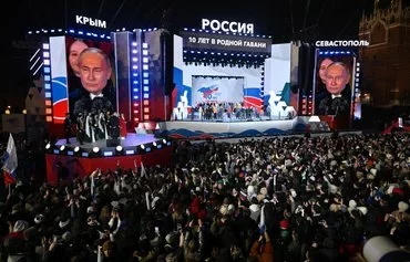 Russian President Vladimir Putin March 18 in Moscow addresses the crowd during a rally celebrating the 10th anniversary of Russia's annexation of Crimea. [Natalia Kolesnikova/AFP]