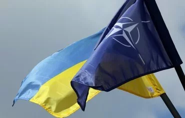 The NATO and Ukrainian flag are pictured in Vilnius, Lithuania, last July 9, a few days ahead of a NATO summit. [Petras Malukas/AFP]