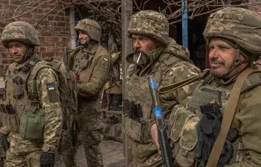 Ukrainian infantrymen of the 23rd Mechanized Brigade wait to head toward the front in the Avdiivka direction, in Donetsk province, on April 3. [Roman Pilipey/AFP]