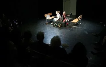 Les Kurbas Theatre actresses Lesya Kostiykova (left) and Sonya Ignatenko (right) perform in the premiere of the dark comedy called 'Light at the End of the Tunnel' by Ukrainian director Anatoliy Levchenko in Kyiv, on April 7, amid the Russian invasion in Ukraine. [Anatolii Stepanov/AFP]