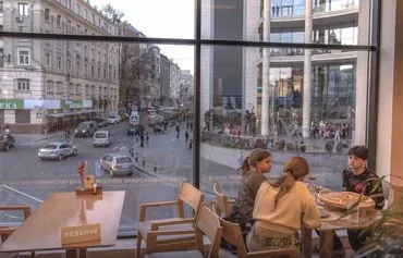 Diners eat in a restaurant during an air strike alarm, in Kharkiv, on April 8, amid the Russian invasion of Ukraine. [Roman Pilipey/AFP]