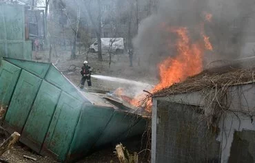 Firefighters extinguish a fire at the site of a missile strike in the center of Kharkiv, on April 7, amid the Russian invasion of Ukraine. [Sergey Bobok/AFP]