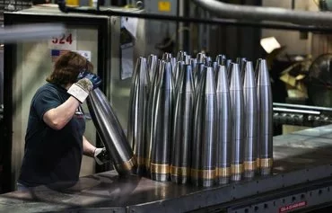 An employee handles 155mm caliber shells after the manufacturing process at the Scranton Army Ammunition Plant (SCAAP) in Scranton, Pennsylvania, on April 16. [Charly Triballeau/AFP]