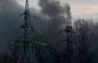 
Smoke billows near electricity towers after a Russian missile strike in Kyiv on March 9, 2023. [Sergei Supinsky/AFP]        