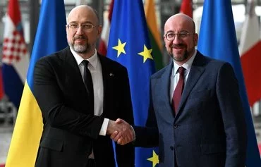 European Council President Charles Michel (right) welcomes Ukrainian Prime Minister Denys Shmyhal (left) before their bilateral meeting at EU headquarters in Brussels, on March 20. [John Thys/AFP]