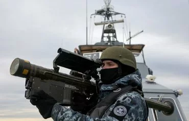 A Ukrainian serviceman holds a Stinger anti-aircraft weapon while scanning for possible air targets, abroad a Ukrainian patrol boat in the Black Sea on December 18, amid the Russian invasion of Ukraine. [Anatolii Stepanov/AFP]