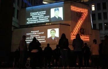 Portraits of Russian service members killed in the Russian-Ukrainian war and the letter 'Z' are seen projected onto the State Council building during a memorial ceremony in Simferopol, Russian-occupied Crimea, on April 9. [AFP]