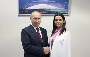 Russian President Vladimir Putin shakes hands with Yevgenia Gutsul, governor of the autonomous region of Gagauzia, Moldova, during the 2024 World Youth Festival outside Sochi, Russia, on March 6. [Mikhail Metzel/AFP]