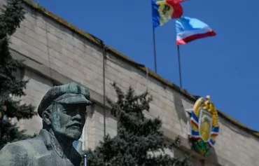 A statue of Lenin is seen next to the government building in Comrat, the main city of Gagauzia, on April 7, 2014. Gagauzia is an autonomous region of Moldova with still-strong nostalgia for the USSR. [Daniel Mihailescu/AFP]