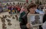 
Relatives and friends of Ukrainian soldiers missing in action against Russian troops April 13 in Kyiv hold portraits and placards during a rally demanding official action to find them. [Roman Pilipey/AFP]        