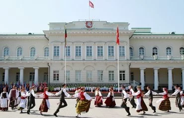 Youths dance during the grand opening of the Students Song Festival in Vilnius on July 6, 2012. Lithuanians vote on May 12 in the first round of a presidential election focused on defense issues, as the Baltic state seeks to boost its security in the face of Russia. [Petras Malukas/AFP]