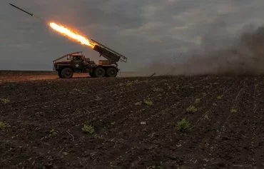 Ukrainian servicemen of the 92nd Assault Brigade fire a BM-21 Grad multiple rocket launcher toward Russian positions, in Kharkiv province, on May 15, amid the Russian invasion of Ukraine. [Roman Pilipey/AFP]